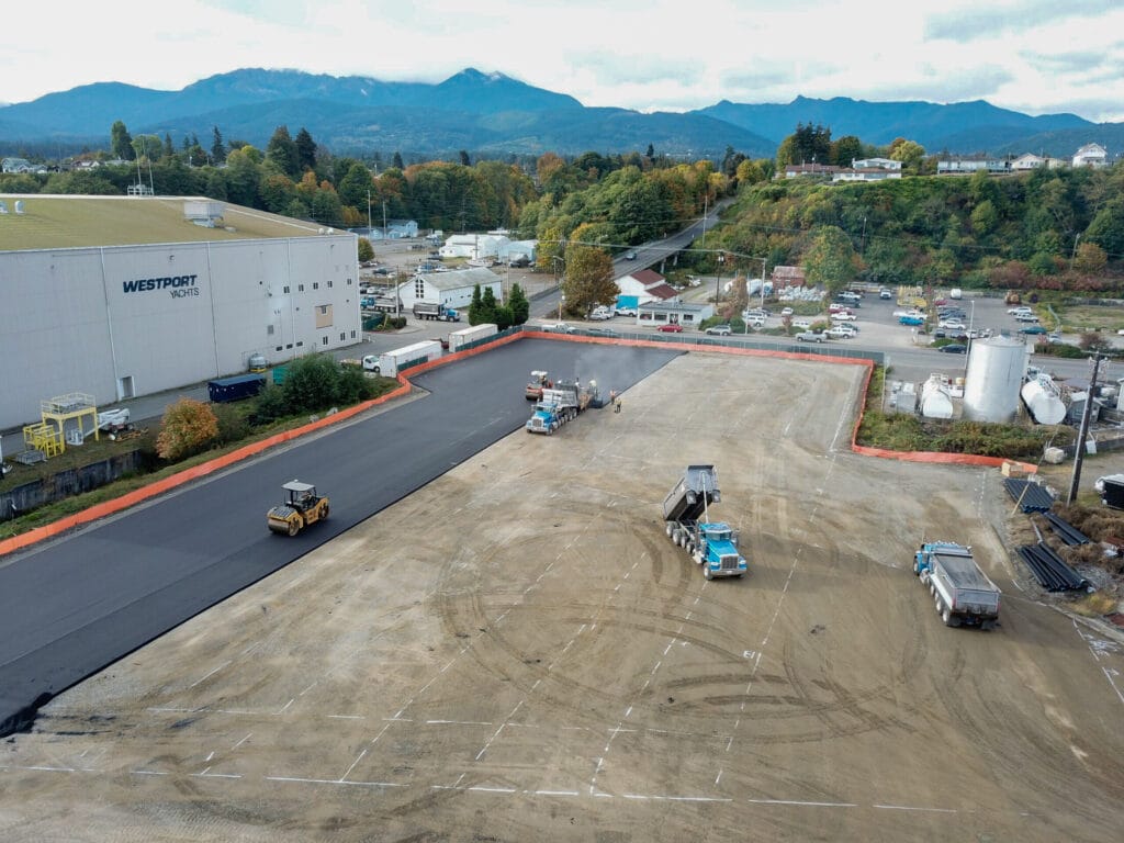Aerial view of a commercial parking lot being paved