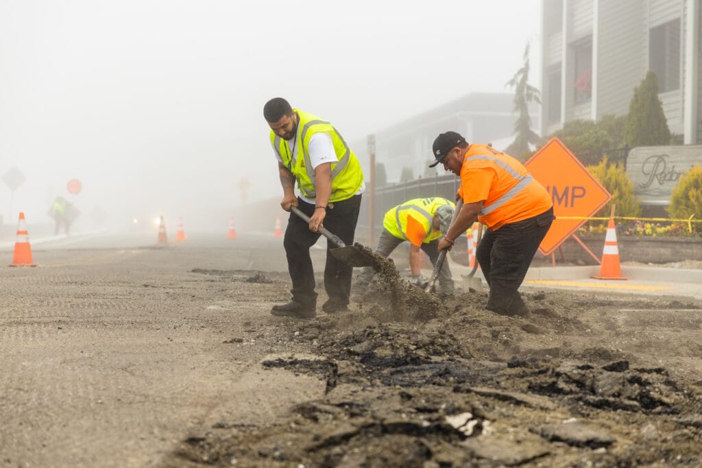Crew digging out failed asphalt for a repair