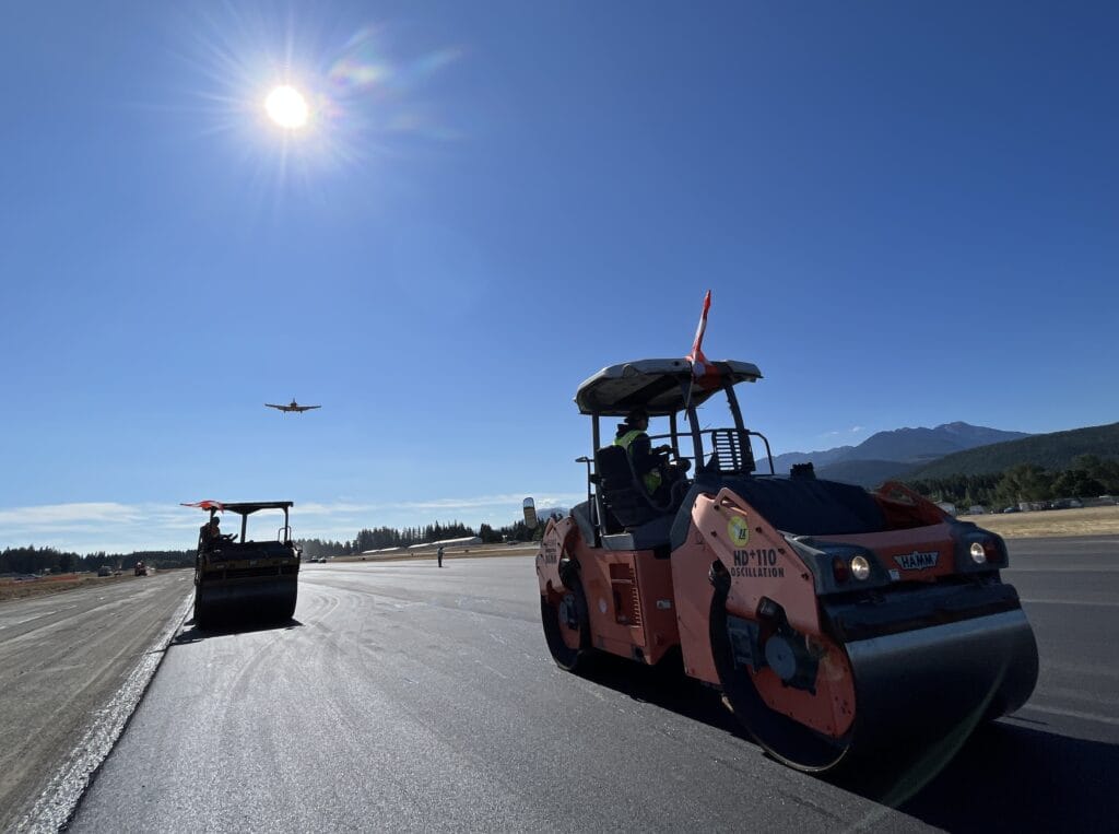 Roller compacting a fresh asphalt runway at an airfield