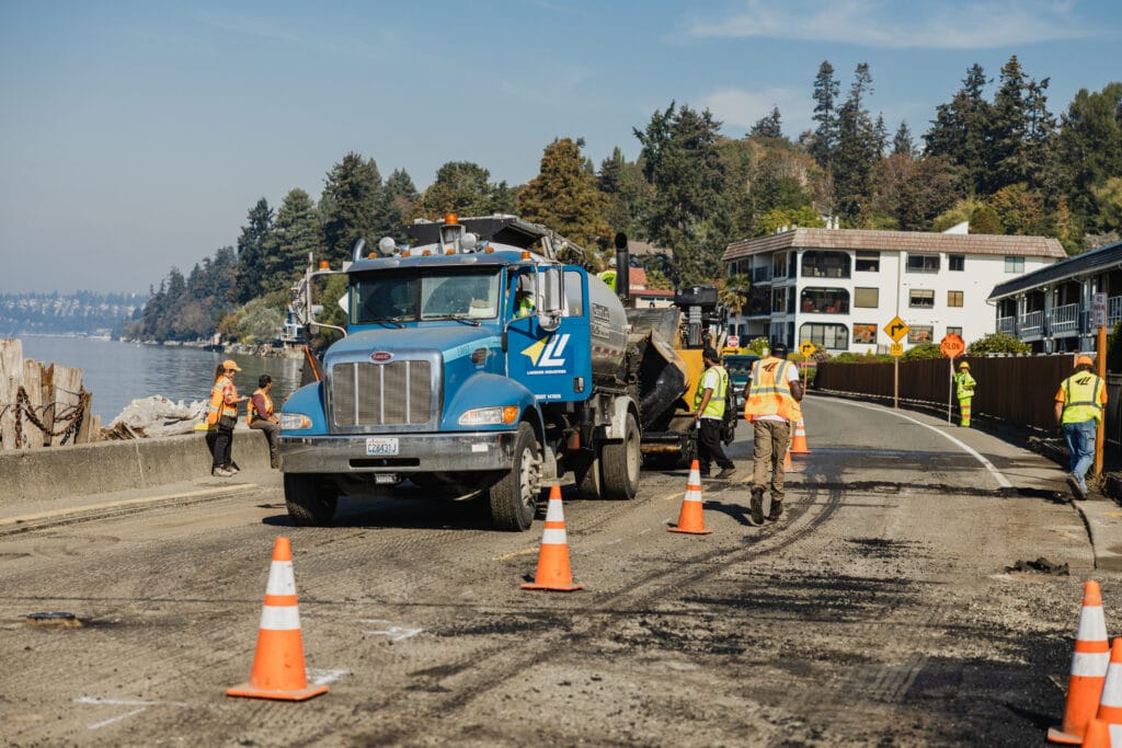 Paving crew and asphalt truck on a road job in Des Moines, WA
