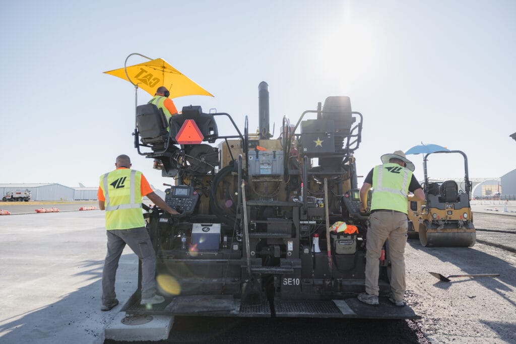 Paver and crew paving the airfield at Paine Field, Everett, WA